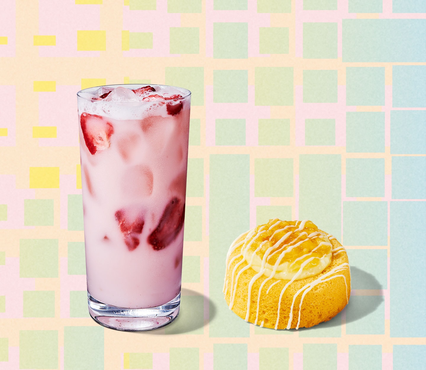 A pink drink in a tall glass with strawberry inclusions next to a pineapple bakery item with a rounded top.