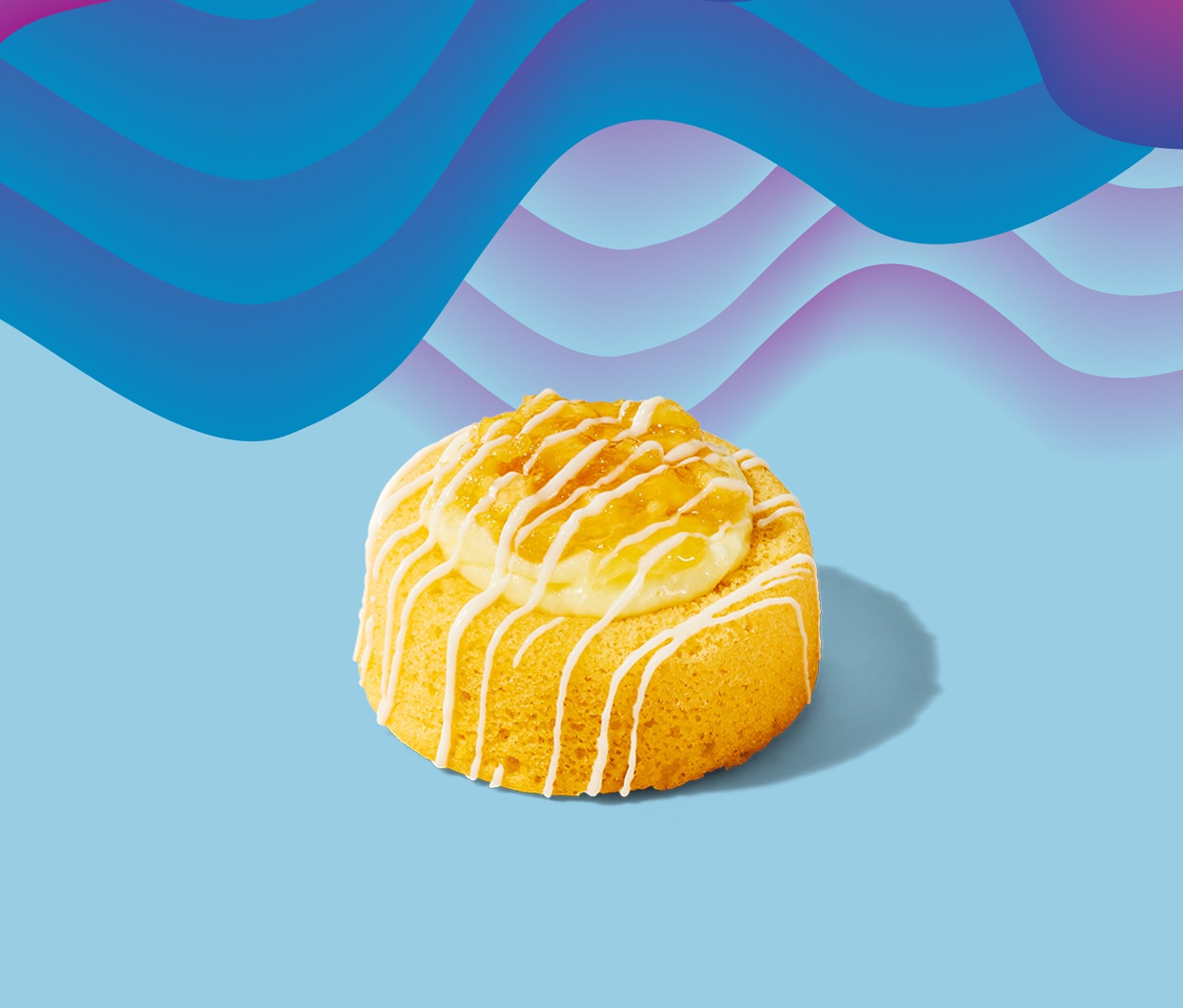 A fluffy yellow cake with a light drizzle of icing.