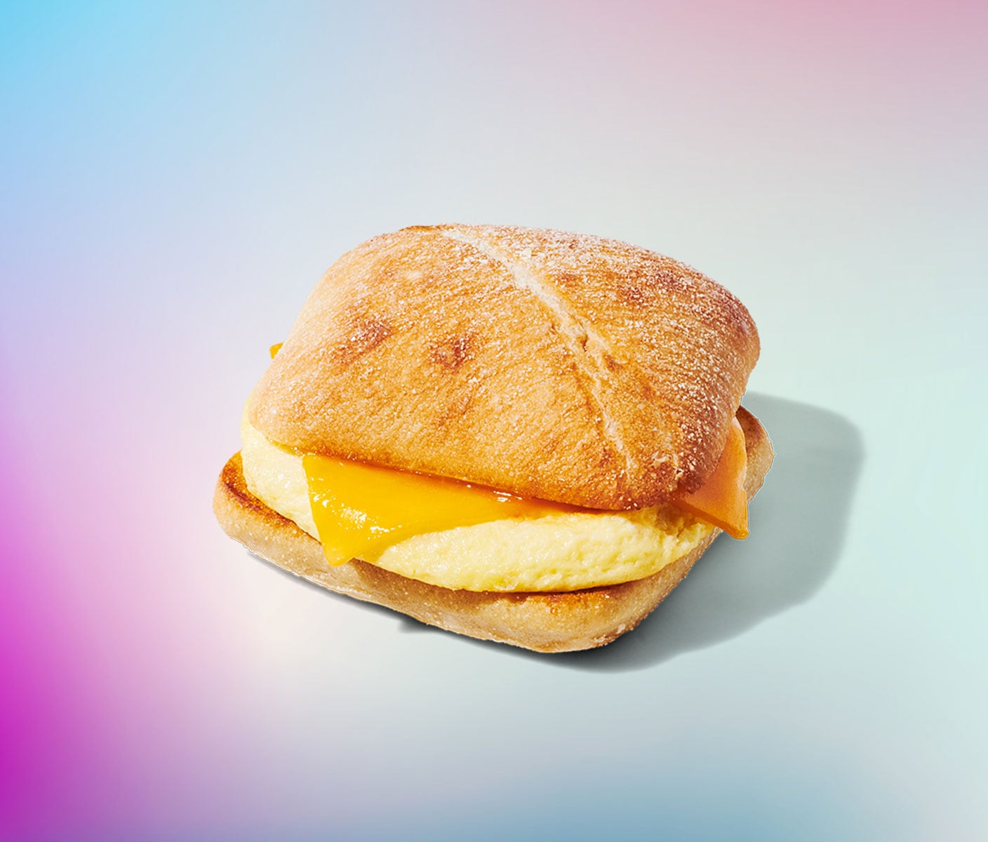 A sandwich with cheese and a fluffy egg patty. 