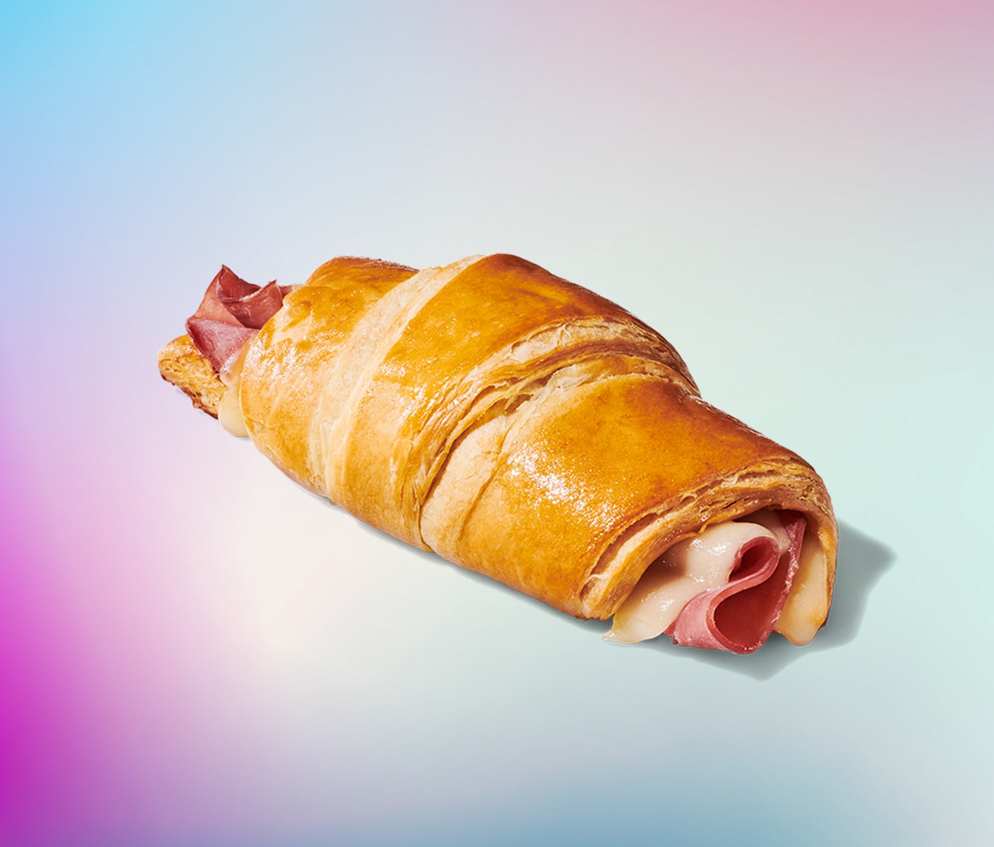 A golden-brown croissant with a ham and swiss cheese filling. 