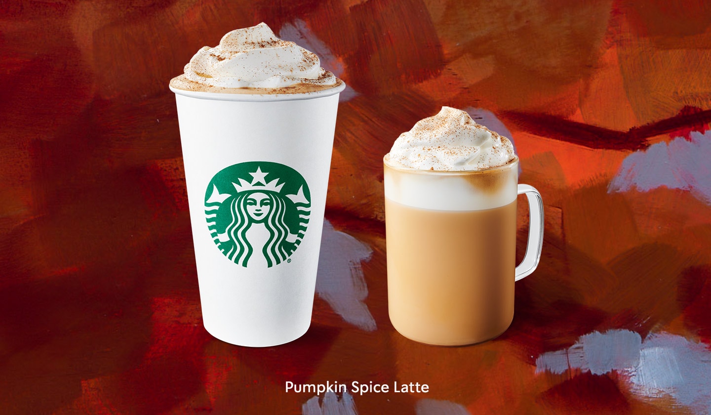 Two Pumpkin Spice Lattes both with swirled pyramids of whipped cream dashed with cinnamon-y dust. One is in a to-go cup and the other is in a glass.