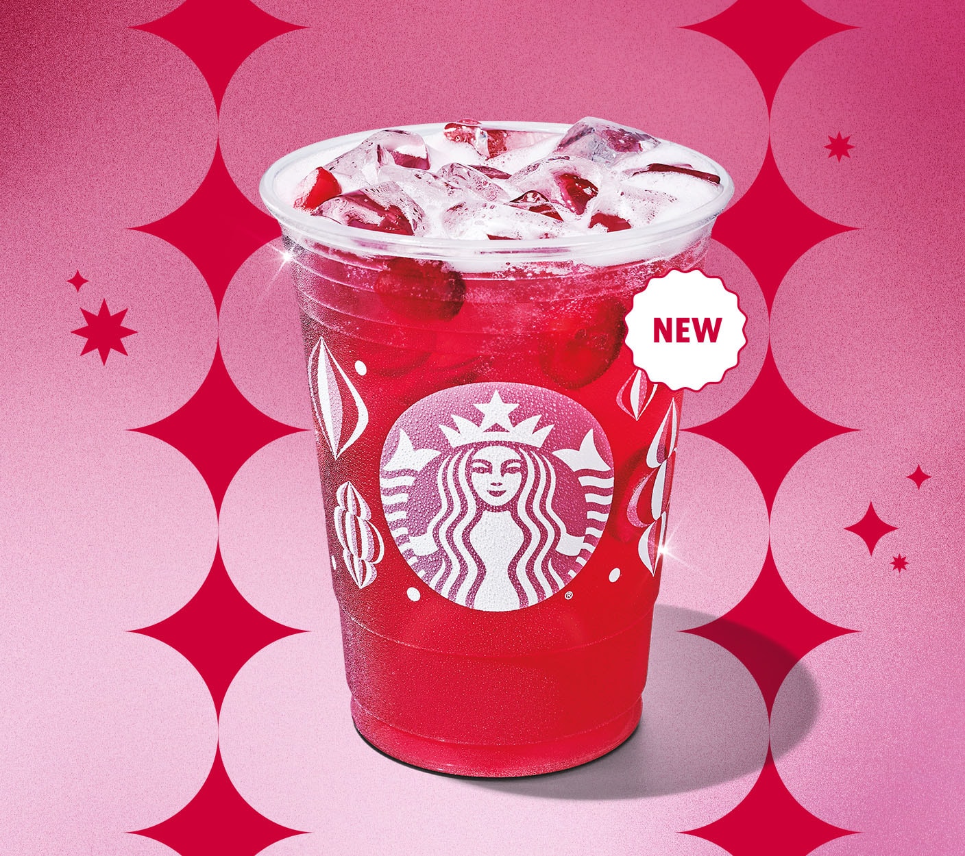 A bright red translucent beverage in a festive patterened cup