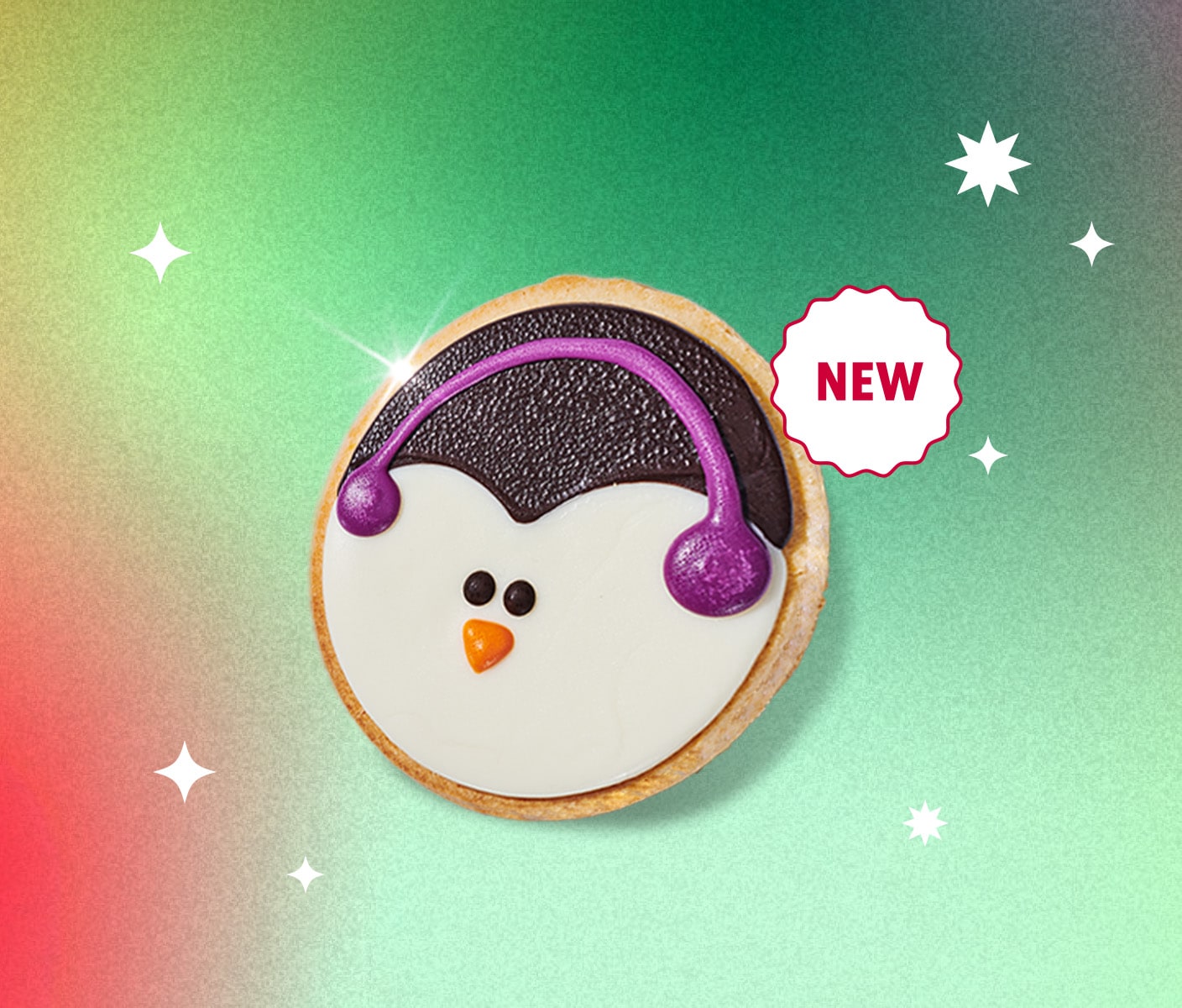 A round sugar cookie decorated to like a Penguin face