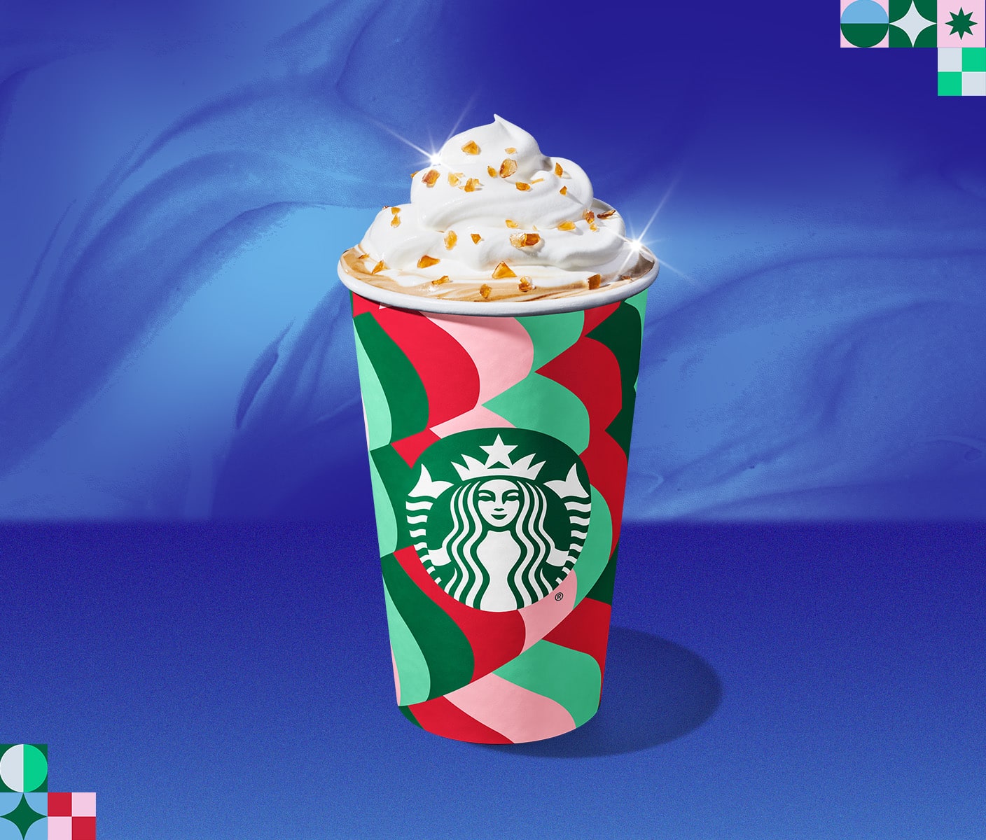 A Starbucks holiday beverage in a takeaway cup