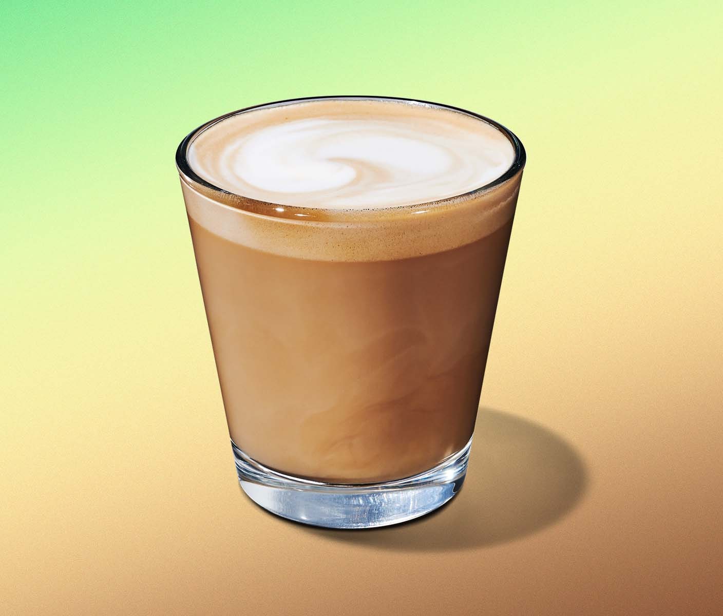 A short espresso beverage with milky crema in a glass sitting on a calming green and yellow gradient.