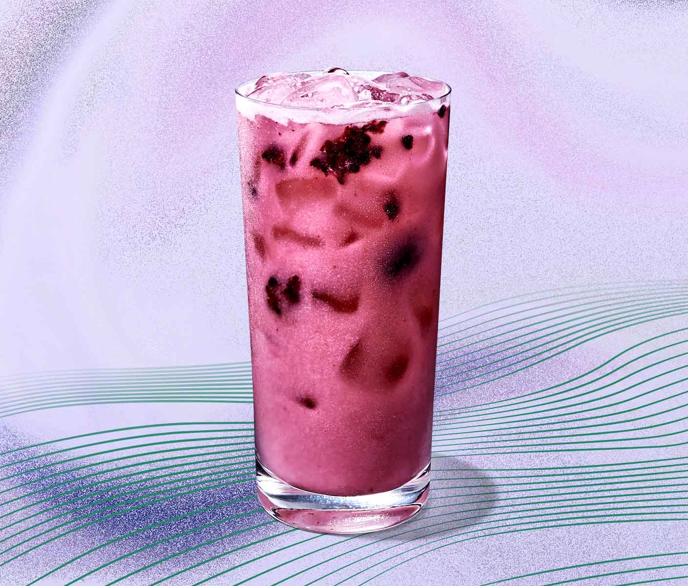 A purple and more opaque Starbucks Refresher beverage in glassware on a pale purple background with radiating green lines.