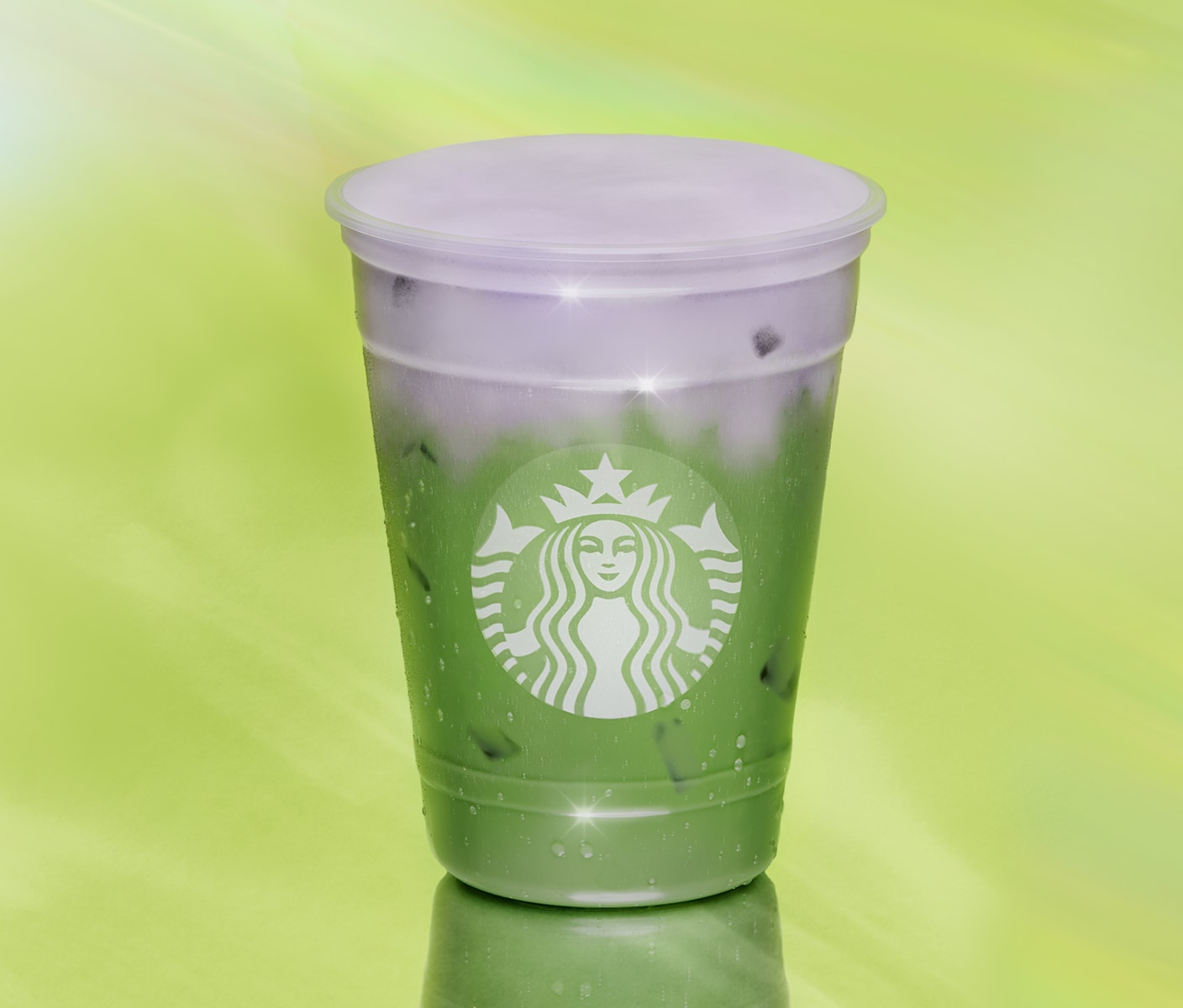 Iced matcha beverage on green background.