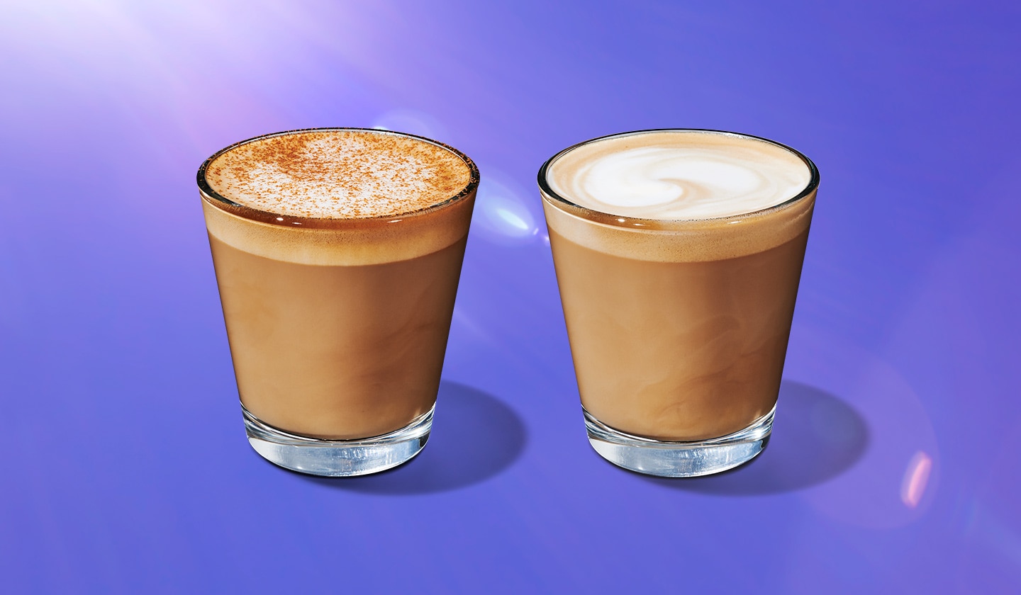 Two hot coffee beverages in glass cups on a purple background.