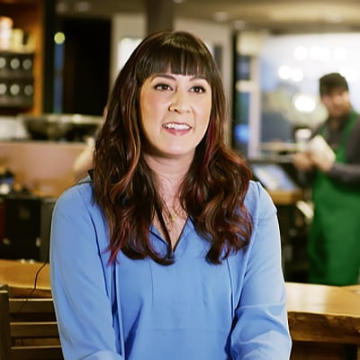 photo of a smiling female store manage with dark brown hair